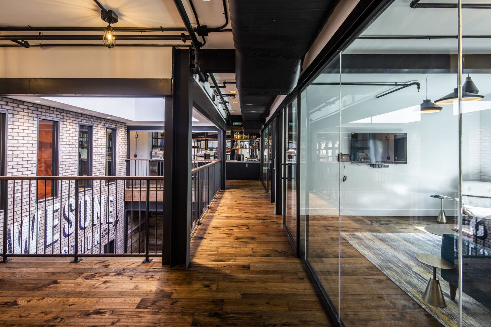 wood floors, natural light and glass wall inside office building